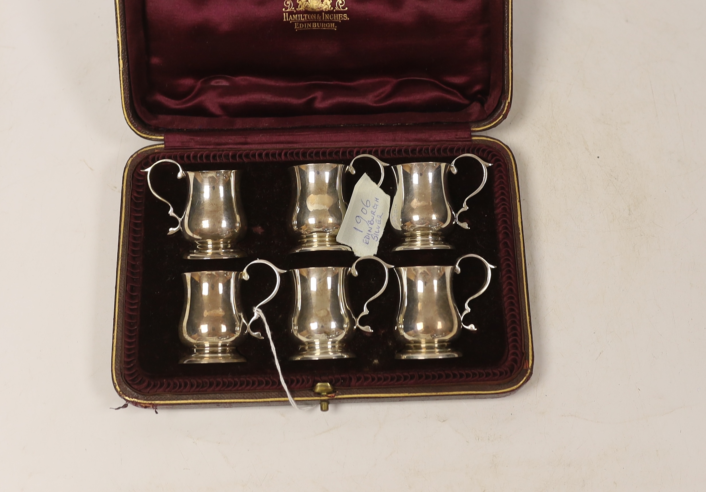 An Edwardian cased set of six miniature baluster mug tots, Hamilton & Inches, Edinburgh, 1906, 49mm.
